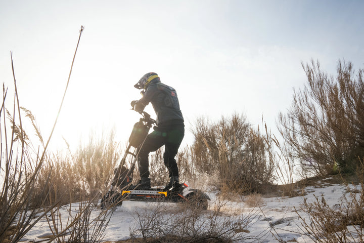 KuKirin electric scooter rider exploring a quiet outdoor road