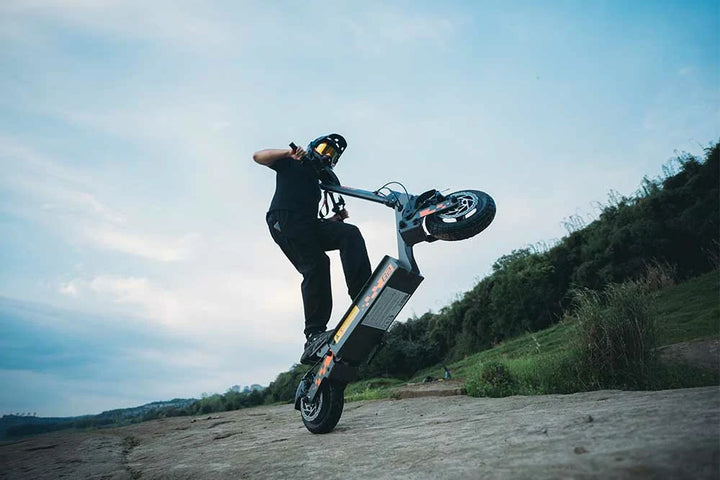 Rider standing on a KuKirin electric scooter on an urban street