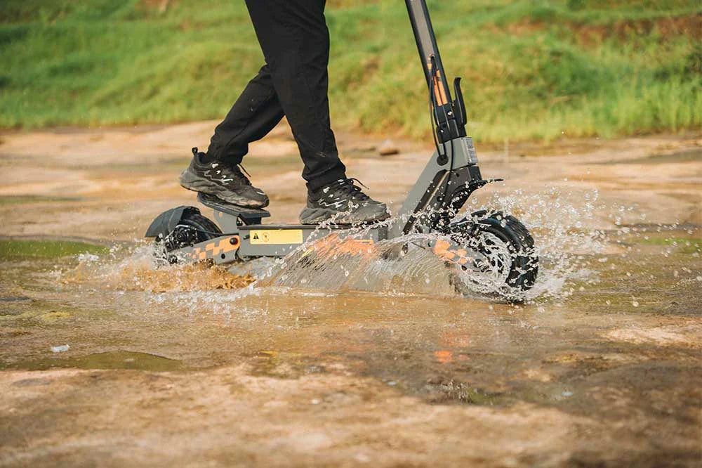 Kukirin electric scooter riding through an open countryside road