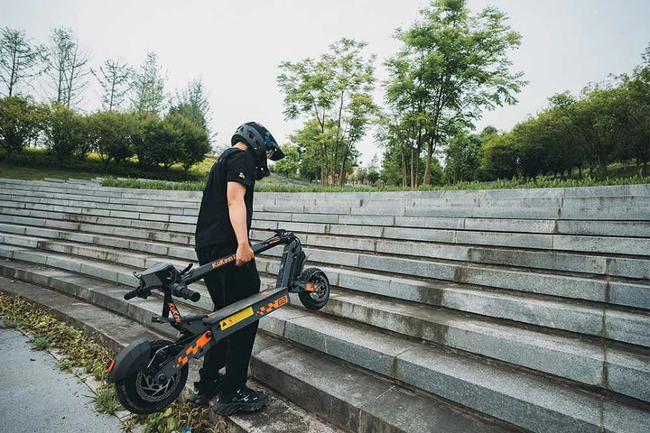 KuKirin electric scooter rider enjoying an outdoor journey on a cloudy day