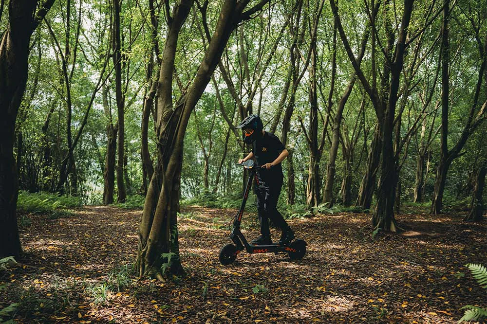 Rider using a KuKirin electric scooter on an open outdoor route