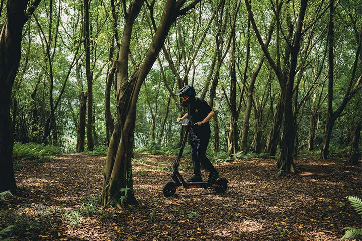 Rider using a KuKirin electric scooter on an open outdoor route