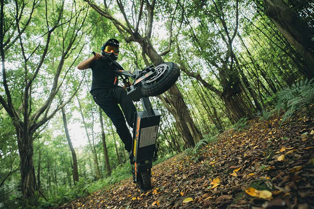 KuKirin G2 electric scooter rider commuting on London cycle lane in casual clothes