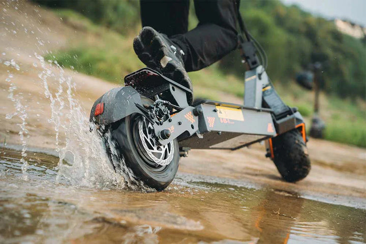 KuKirin G4 electric scooter parked beside a riverside path