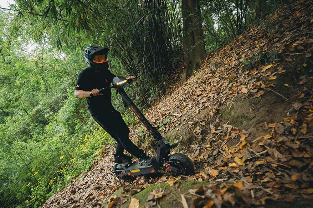 KuKirin G4 electric scooter riding through a countryside road