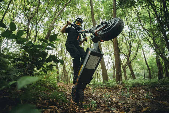 KuKirin electric scooter riding along an open countryside road