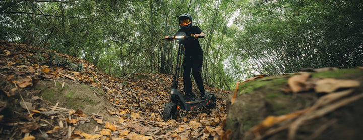 KuKirin electric scooter riding through countryside road